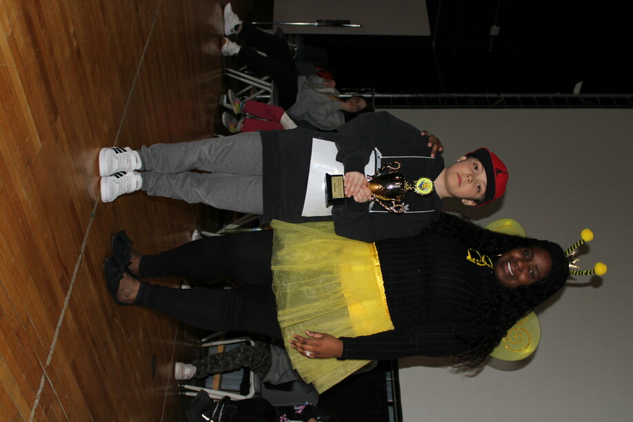 Photo of teacher dresses a Bee from LREC and student who won the Spelling Bee.