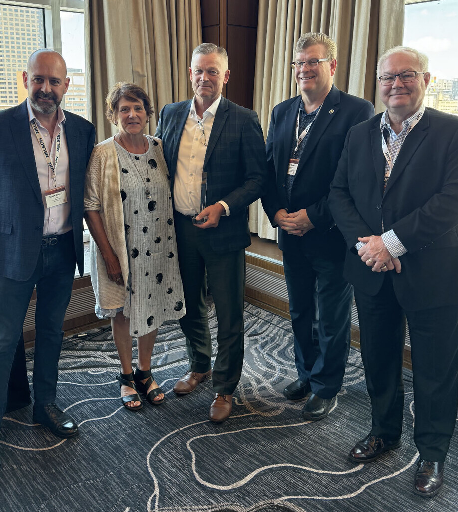 Photo showing 5 people standing together.