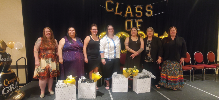 A group photo of the graduates, celebrating their accomplishment! From left to right stands: Assistant Superintendent -- Erica Hildebrand, Krystle Turner, Cydney Bjerke, Angela Christian, Tammy Turner,  Home Placement/P.E.N.T Coordinator -- Debra Perih, A